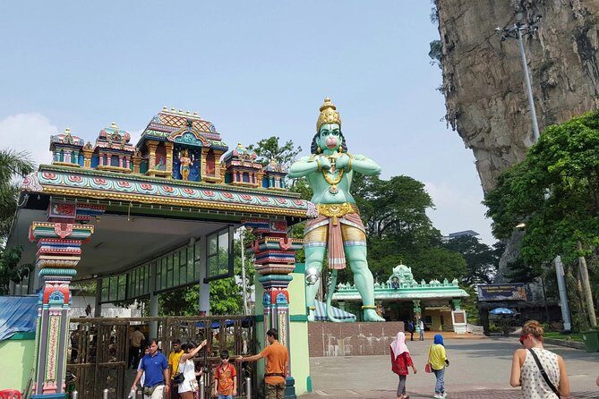 Batu Caves Tour from Kuala Lumpur - First stop: the entrance temple scene, the big statue, and monkeys